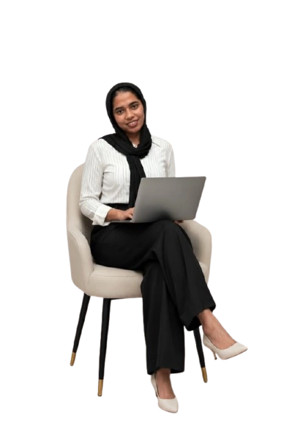 “A woman wearing a black hijab, white top and black pants, sitting on a chair with a laptop on her lap.”